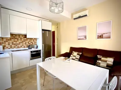 a kitchen with a couch and a table in a room at MyChoice Meninas in Rota