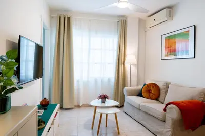 a living room with a couch and a table at Casa Carmen - Super céntrico y cómodo in Jerez de la Frontera