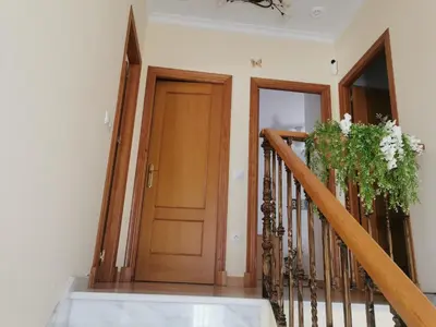 a staircase with a wooden door and a plant at Casa Ye Ye in Novo Sancti Petri