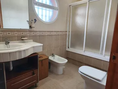 a bathroom with a sink and a toilet and a mirror at Casa Ye Ye in Novo Sancti Petri