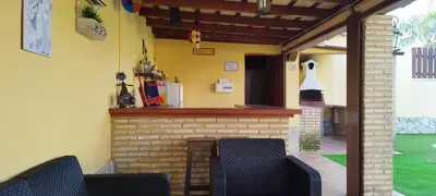 a patio with two chairs and a brick fireplace at Casa Ye Ye in Novo Sancti Petri