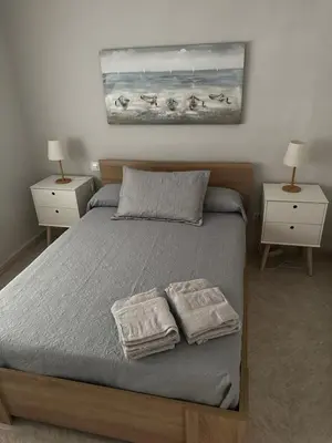 a bedroom with a bed with two towels on it at Apartamento Sotest in Jerez de la Frontera