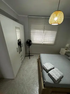 a bedroom with a bed with two towels on it at Apartamento Sotest in Jerez de la Frontera