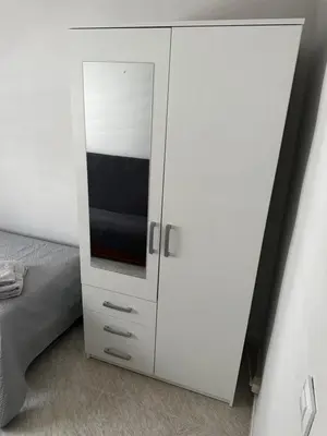 a white cabinet with a tv on it next to a bed at Apartamento Sotest in Jerez de la Frontera