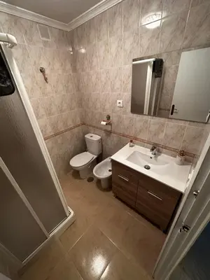 a bathroom with a sink and a toilet and a mirror at Apartamento Sotest in Jerez de la Frontera