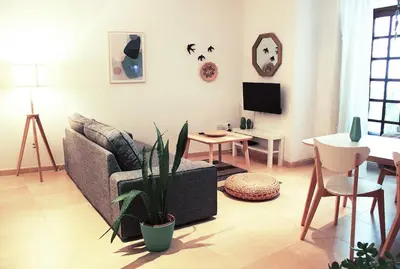 a living room with a couch and a table at Fancy apartment in a Historic house, Chiclana City Center by C. Dreams in Chiclana de la Frontera