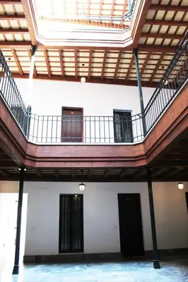 an empty room with a staircase in a building at Fancy apartment in a Historic house, Chiclana City Center by C. Dreams in Chiclana de la Frontera