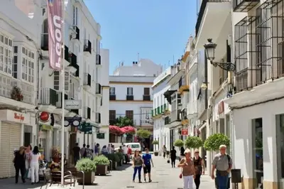 a wooden boardwalk on a beach with the ocean at Fancy apartment in a Historic house, Chiclana City Center by C. Dreams in Chiclana de la Frontera