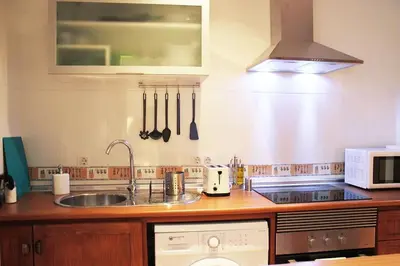 a kitchen with a sink and a dishwasher at Fancy apartment in a Historic house, Chiclana City Center by C. Dreams in Chiclana de la Frontera