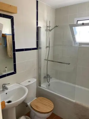 a bathroom with a toilet and a sink and a shower at bamboo & golf house in Campano