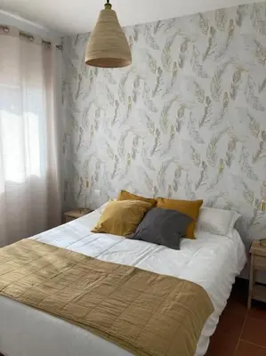 a bedroom with a large bed with a wall at bamboo & golf house in Campano