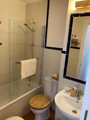 a bathroom with a toilet and a shower and a sink at bamboo & golf house in Campano