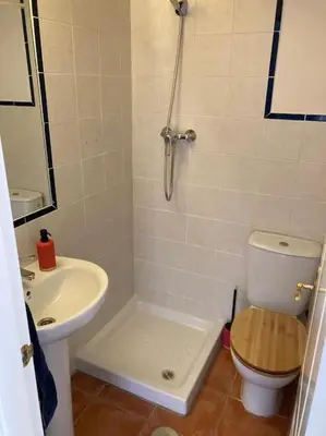 a small bathroom with a toilet and a sink at bamboo & golf house in Campano