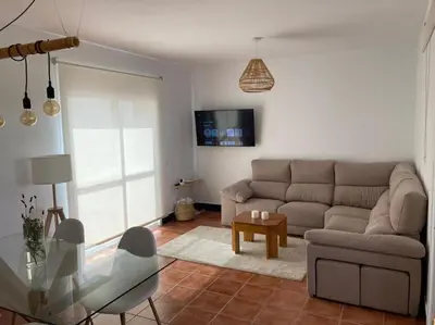 a living room with a couch and a glass table at bamboo & golf house in Campano