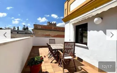 a patio with a table and chairs on a balcony at Ático céntrico con terraza privada y plaza de garaje in Sanlúcar de Barrameda