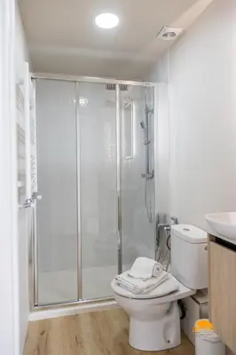 a bathroom with a shower with a toilet and a sink at Malibu by Cadiz Time in Cádiz