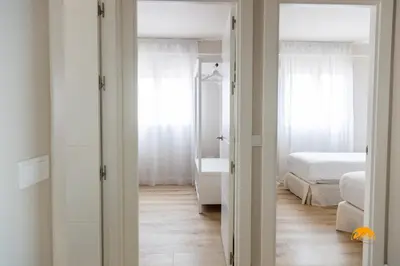 a bedroom with a bed and a bathroom with a tub at Malibu by Cadiz Time in Cádiz