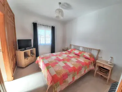 a bedroom with a bed and a television in it at Charming villa in Chiclana de la Frontera with private pool in Chiclana de la Frontera