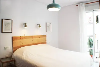 a bedroom with a white bed and a window at Enjoy the historic center of Chiclana By C. Dreams in Chiclana de la Frontera