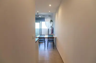 a hallway leading to a kitchen with a table and chairs at El Beduino by Gades Gestión in Cádiz