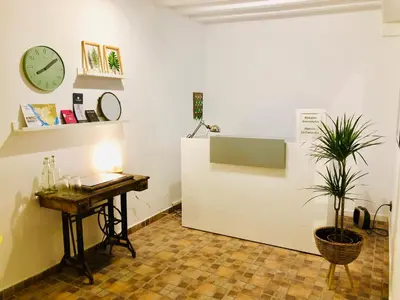 a room with a desk and a clock on the wall at Pensión La Cantarera in Cádiz