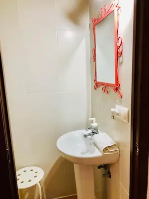 a bathroom with a sink and a mirror at Pensión La Cantarera in Cádiz