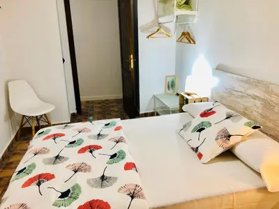 a bed with two pillows with umbrellas on it at Pensión La Cantarera in Cádiz