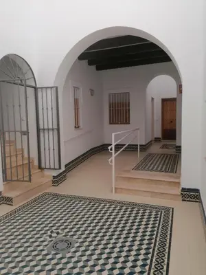 an empty room with a tile floor in a building at Apartamento Pale Cream in Jerez de la Frontera