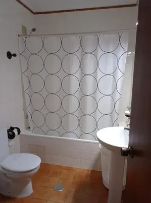 a hallway with a table and a mirror on a wall at Cruces, piso en pleno centro urbano in Sanlúcar de Barrameda