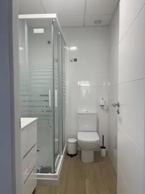 a white bathroom with a sink and a mirror at Anpartamento con Encanto Costa Ballena in Costa Ballena