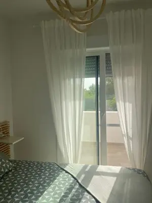a white bathroom with a toilet and a sink at Anpartamento con Encanto Costa Ballena in Costa Ballena