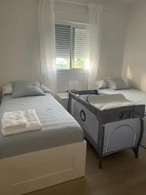a bedroom with two beds and a window at Anpartamento con Encanto Costa Ballena in Costa Ballena