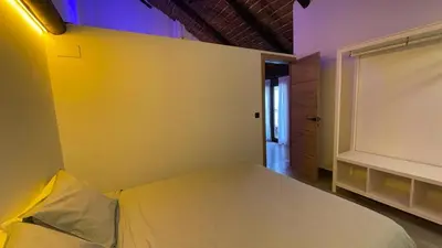 a bedroom with a white bed and a window at Casa del lago in Sanlúcar de Barrameda