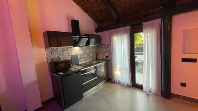 a kitchen with a stove and a microwave at Casa del lago in Sanlúcar de Barrameda