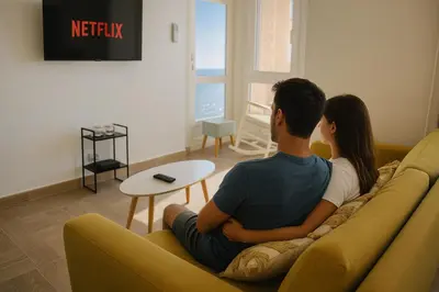 a man and a woman sitting on a couch at Skyline - Beach apartment with breathtaking views and more in Cádiz