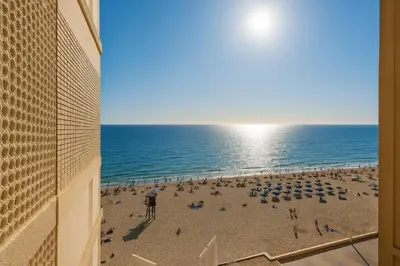 a view of a beach with umbrellas and the ocean at Skyline - Beach apartment with breathtaking views and more in Cádiz