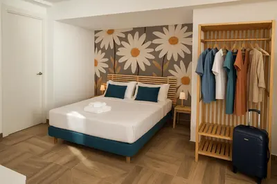 a bedroom with a bed and a wall with flowers at Skyline - Beach apartment with breathtaking views and more in Cádiz