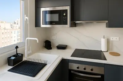 a kitchen with a stove and a microwave at Skyline - Beach apartment with breathtaking views and more in Cádiz