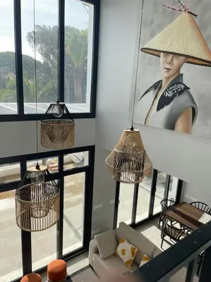 a living room with two lamps and a picture of a woman at Villa Cactae in Novo Sancti Petri