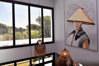 a room with a picture of a woman wearing a hat at Villa Cactae in Novo Sancti Petri