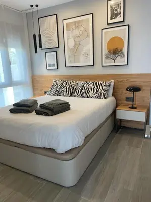a bedroom with a large bed with a zebra print pillow at Villa Cactae in Novo Sancti Petri