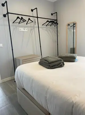 a bedroom with a white bed with a black frame at Villa Cactae in Novo Sancti Petri
