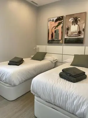 a room with two beds with towels on them at Villa Cactae in Novo Sancti Petri