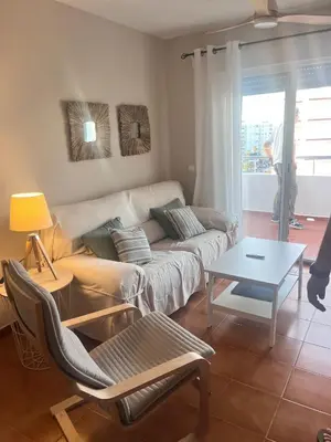 a living room with a couch and a table at Apartamento en primera línea de playa Valdemar 1 in El Puerto de Santa María