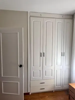 a white closet with white cabinets and a door at Apartamento en primera línea de playa Valdemar 1 in El Puerto de Santa María