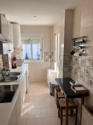 a kitchen with a sink and a table in it at Apartamento en primera línea de playa Valdemar 1 in El Puerto de Santa María