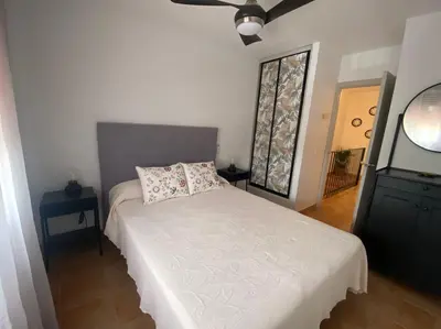 a bedroom with a bed with a pillow and a window at Apartamento La Balconera 1ª línea de Playa in Chiclana de la Frontera