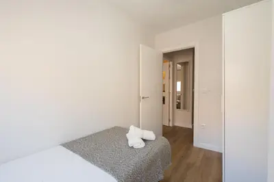 a white room with a bed and a mirror at Apartoyou - Enamorados in El Puerto de Santa María