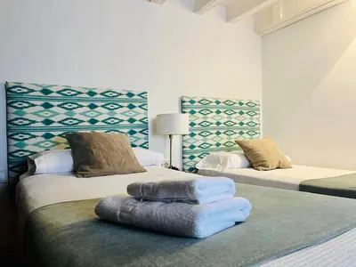 a room with two beds with towels on them at La Botica Grupo AC Gestion in Cádiz