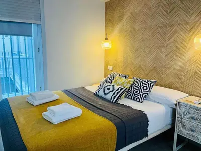 a bedroom with a bed with two towels on it at La Botica Grupo AC Gestion in Cádiz